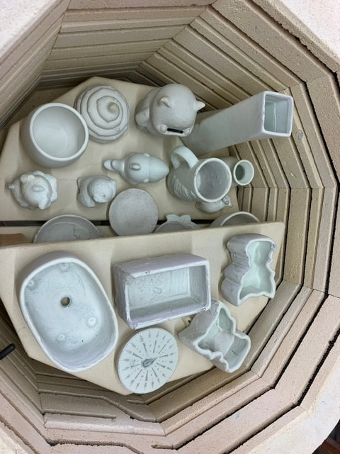 Bisque pieces loaded in the kiln before firing