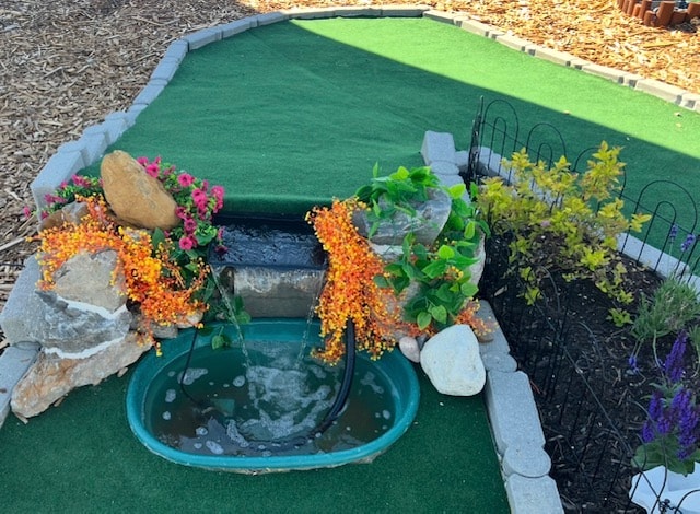 Family enjoying a round of mini golf